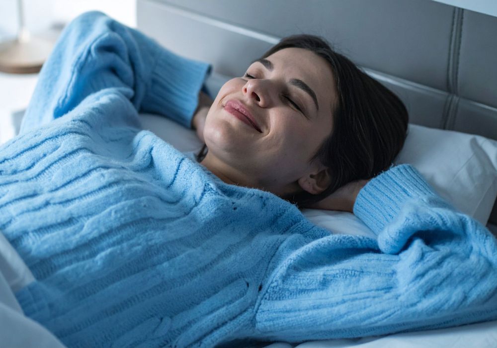 Mujer en calma, respirando profundamente antes de dormir, practicando hábitos nocturnos para mejorar el sueño en la menopausia