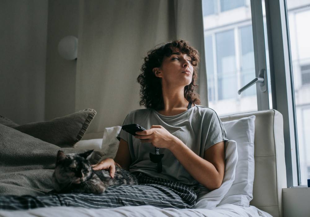 Woman finding calm with her pet after managing anger during menopause, natural emotional support