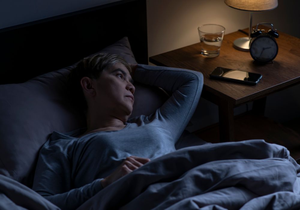Mujer despierta de noche por los efectos de la progesterona en la menopausia